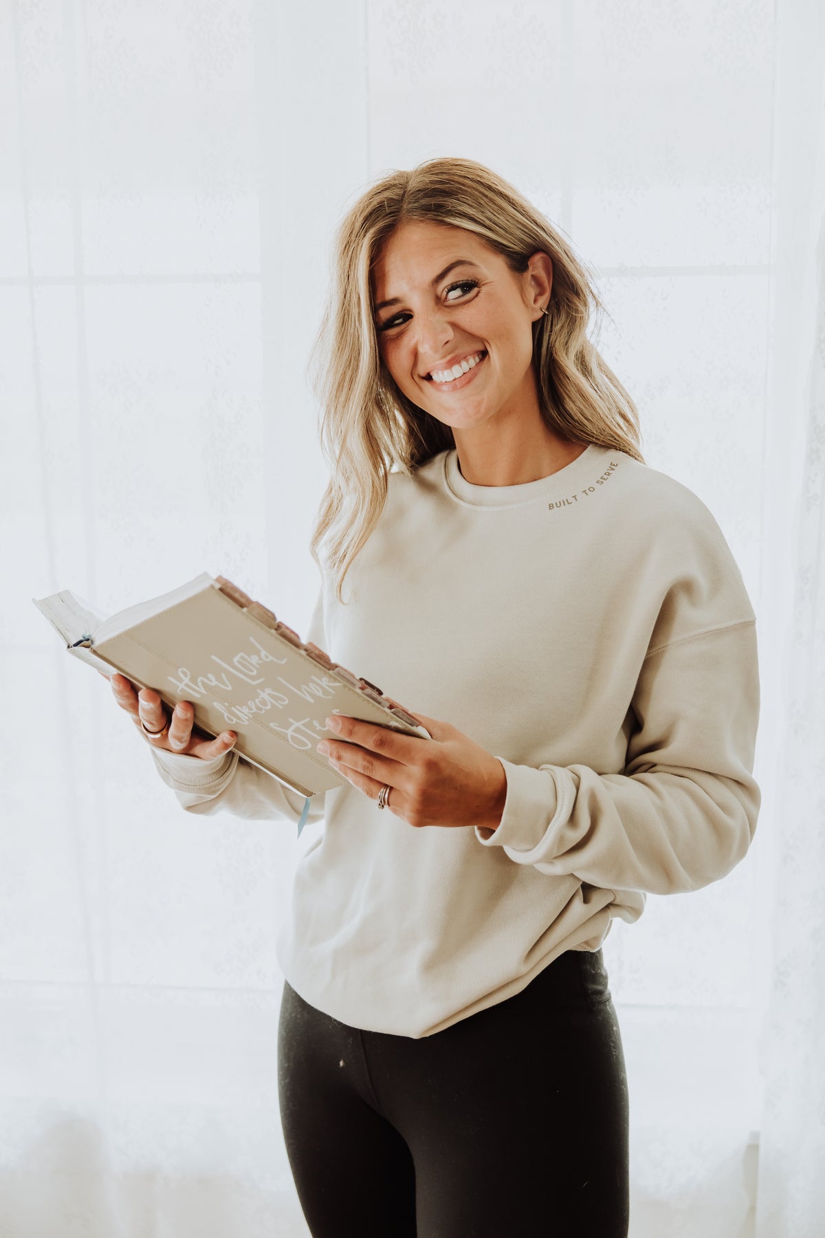 Woman holding a book against a white background
